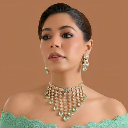 Gold kundan polki choker necklace set with mint green pear drops and matching floral earrings by Auraa Trends