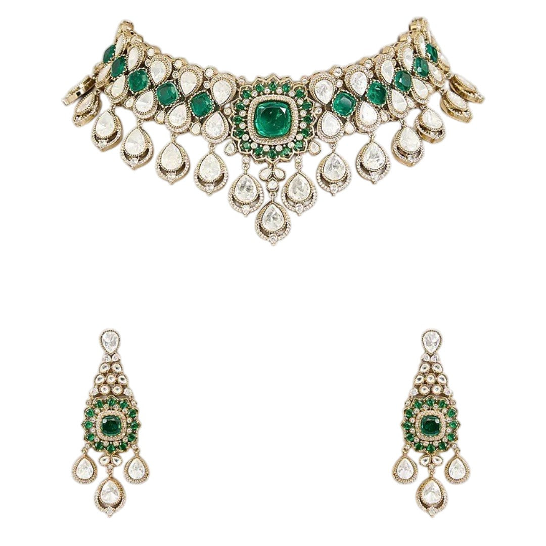 "Antique gold Kundan choker necklace with cushion-cut emerald center and polki teardrop drops, matching chandelier earrings"