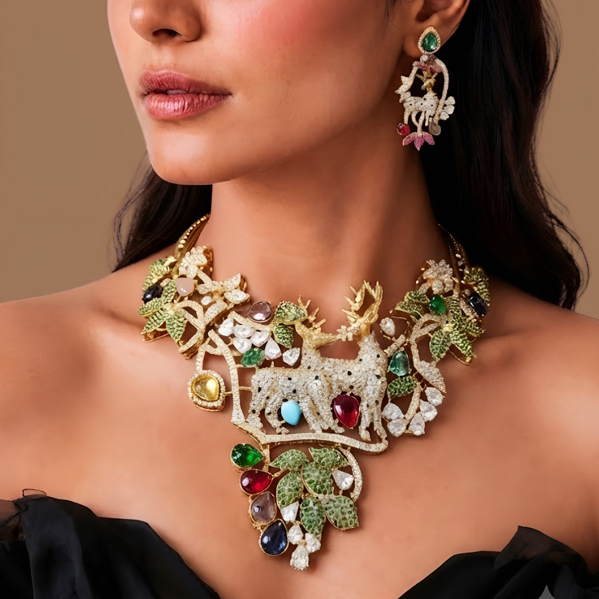 Gold plated deer motif statement necklace with zircon leaves and multicolour stones on a display bust