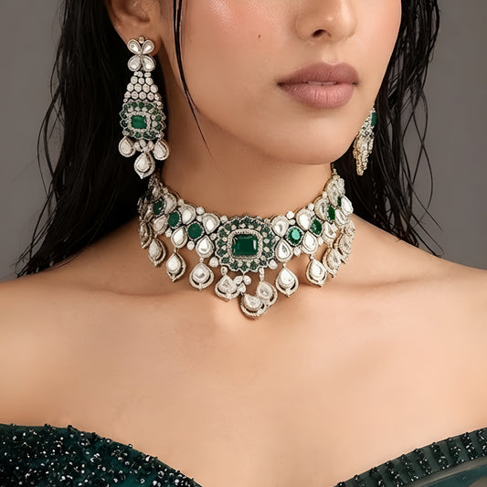 "Antique gold Kundan choker necklace with cushion-cut emerald center and polki teardrop drops, matching chandelier earrings"