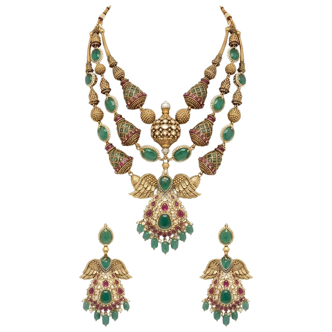 "Antique gold plated kundan polki bridal necklace set with emerald and ruby stones, peacock wing pendant design, and matching jhumka earrings"