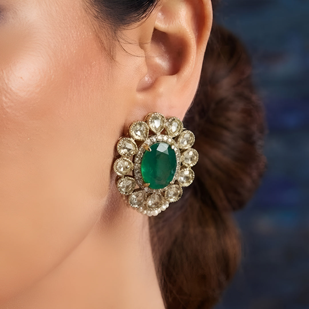 Designer gold-plated Kundan pearl choker necklace set with green centerpiece, floral pink stones, and matching stud earrings for women.