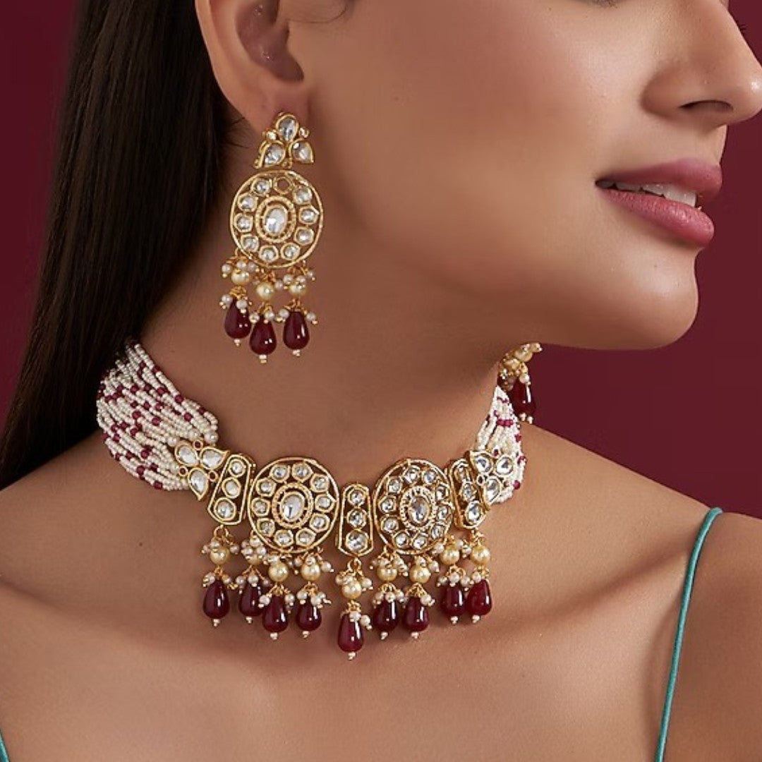Kundan choker necklace with two round medallions, ruby-red teardrop beads and white pink beaded strands, shown with matching earrings