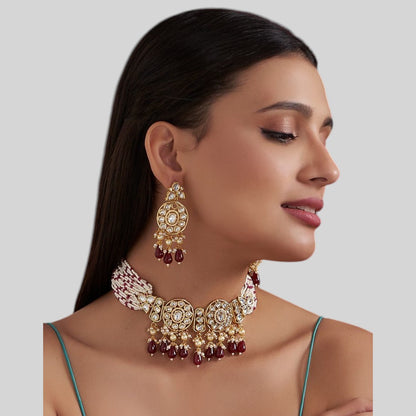 Kundan choker necklace with two round medallions, ruby-red teardrop beads and white pink beaded strands, shown with matching earrings