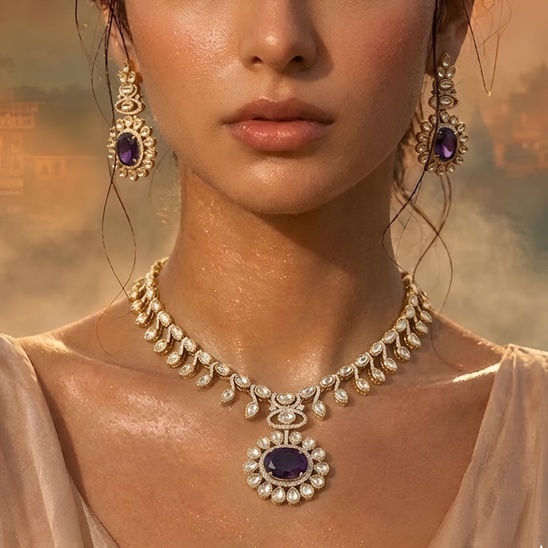 Gold-tone Kundan-inspired necklace and earrings set featuring white stones and deep purple oval gemstone accents in an elegant traditional design.