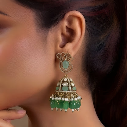 Antique gold Kundan jhumka earrings featuring aqua green stones, pearl accents, and green bead drops for women.