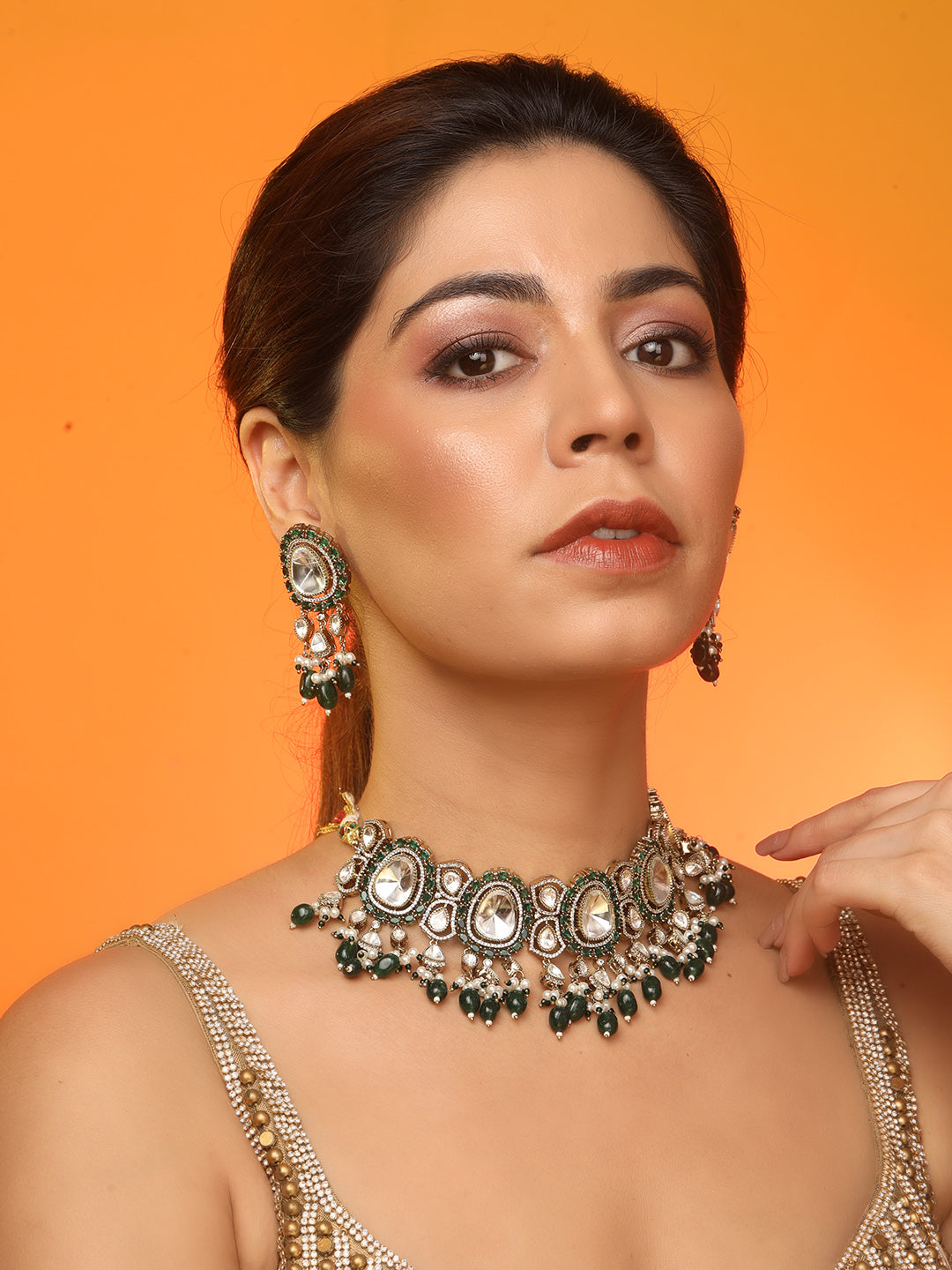 Elegant gold-tone choker necklace set with large mirror-polished stones, green bead accents, and pearl detailing, paired with matching dangling earrings