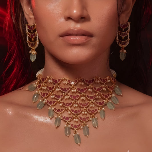 "Layered Kundan choker necklace and earring set in maroon gold with pearl and green bead drops, bridal jewellery styled on model"