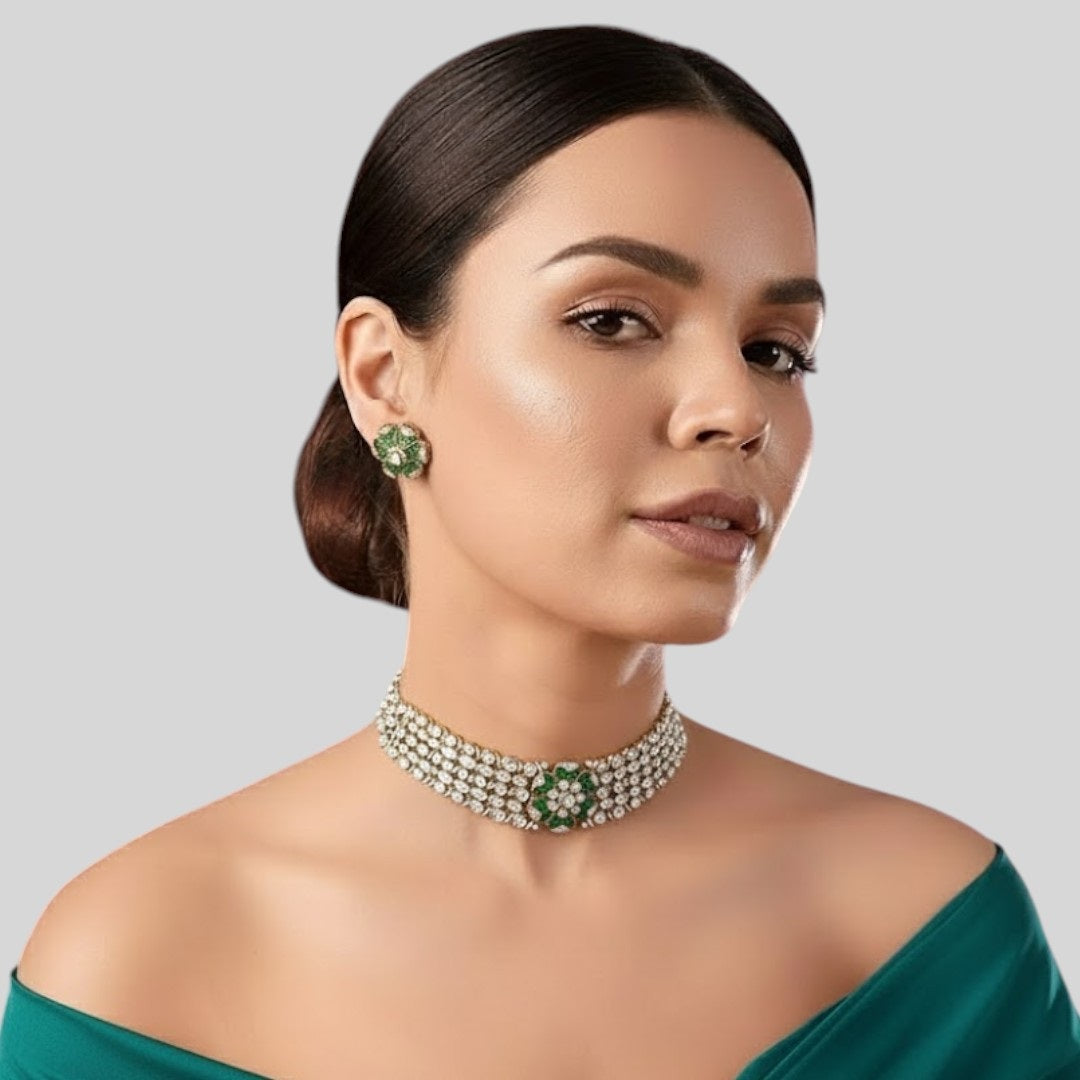 "Green floral American Diamond choker necklace set with matching stud earrings, featuring white AD stones, gold finish and adjustable yellow dori, displayed on a dark background."