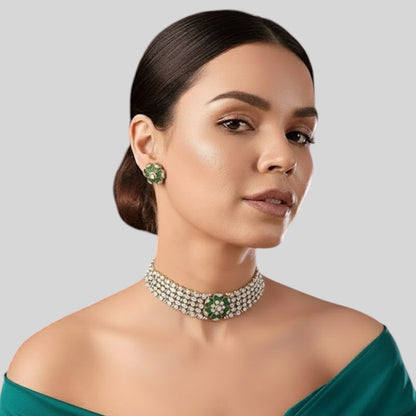 "Green floral American Diamond choker necklace set with matching stud earrings, featuring white AD stones, gold finish and adjustable yellow dori, displayed on a dark background."