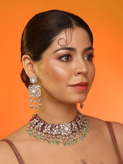 Kundan bridal necklace set with pink stones, green bead drops, and matching statement earrings in gold tone
