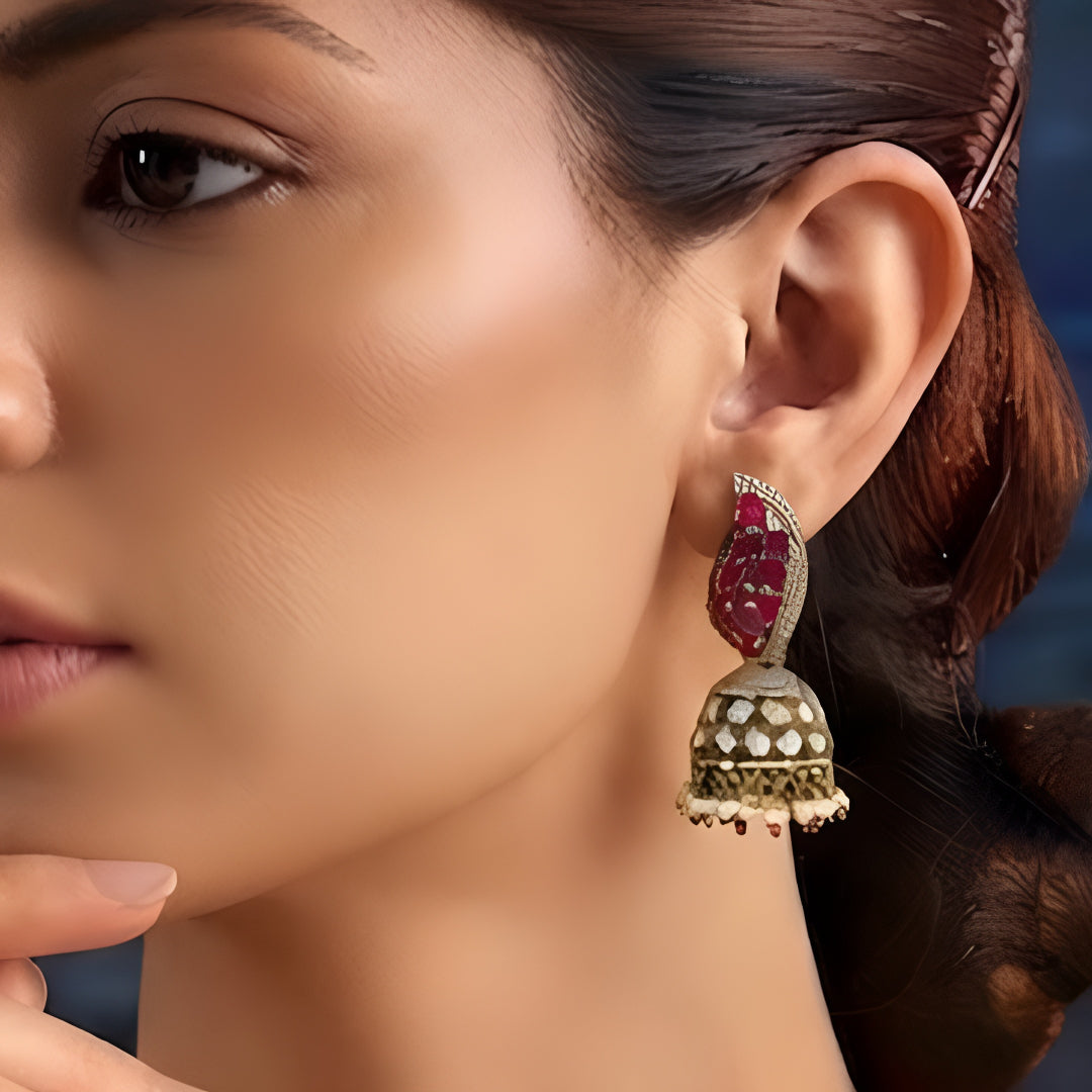 Antique gold Kundan jhumka earrings with ruby stones, sparkling American diamonds, and pearl drop fringe for women.