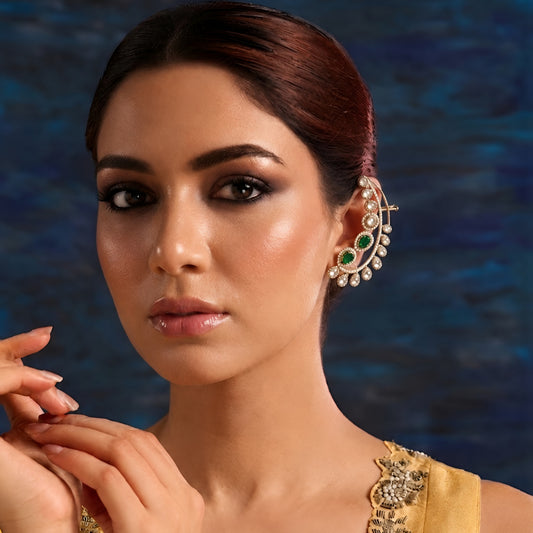 Luxury gold-plated ear cuff earrings with sparkling American diamonds and emerald green pear-shaped stones for women.