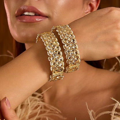 Gold-plated Kundan bangles with teardrop stones and pearl bead detailing for women, ideal for bridal and festive wear.