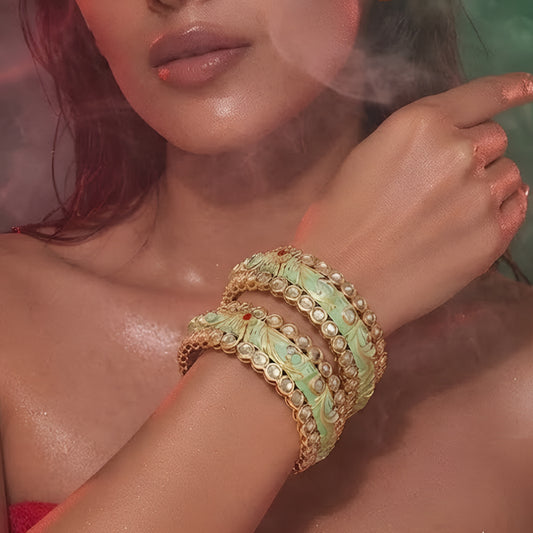 Mint green Meenakari-inspired AD studded gold tone designer bangle set with floral detailing
