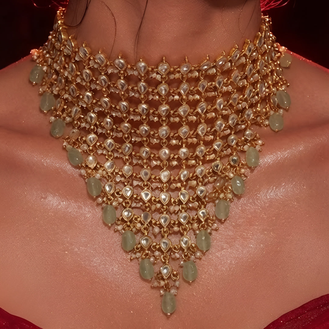 "Woman wearing gold Kundan choker necklace set with green beaded drops and matching chandbali earrings, bridal jewellery"