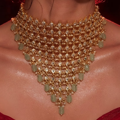 "Woman wearing gold Kundan choker necklace set with green beaded drops and matching chandbali earrings, bridal jewellery"