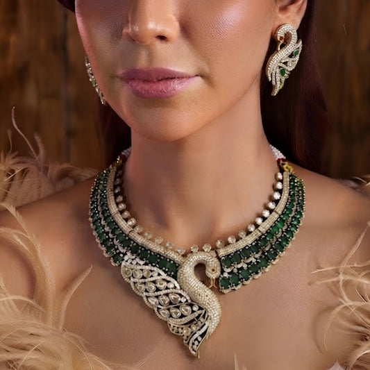 Luxury green swan designer necklace set with American diamonds, emerald green stones, and matching swan earrings for bridal wedding and party wear.