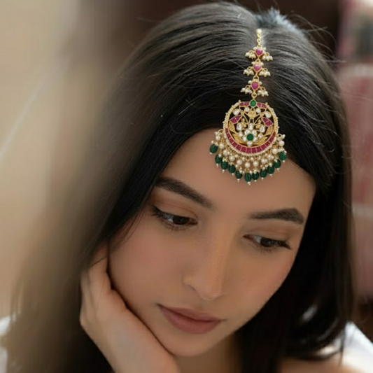 Traditional gold-plated Kundan maang tikka with ruby, emerald, and pearl detailing – bridal headpiece for women