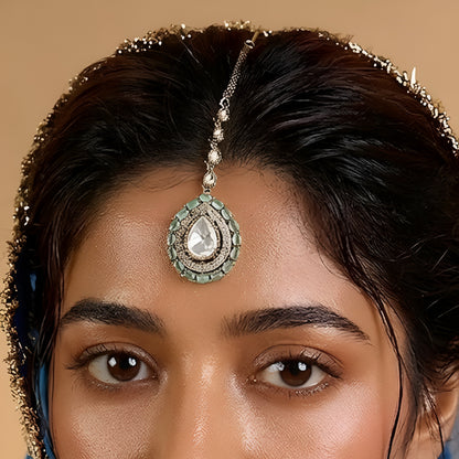 Gold-plated mint green Kundan maang tikka with teardrop American Diamond pendant for bridal, wedding, festive, and ethnic wear.