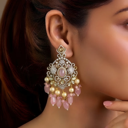 Pink Kundan Chandbali earrings featuring a blush pink center stone, sparkling Kundan detailing, pearl drops, and pink bead tassels with a gold-plated finish.