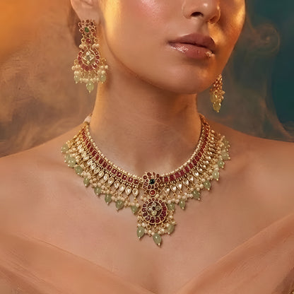 Traditional Kundan choker necklace set with ruby stones, green bead drops, gold finish, and matching earrings for bridal and wedding wear.