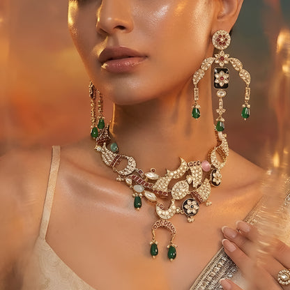 Designer gold-plated kundan necklace set with floral enamel motifs, pink stone accents, sparkling white kundan work, green bead drops, and matching statement earrings.