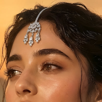 Silver-plated American Diamond floral maang tikka with dangling CZ stones for bridal, wedding, festive, and party wear.
