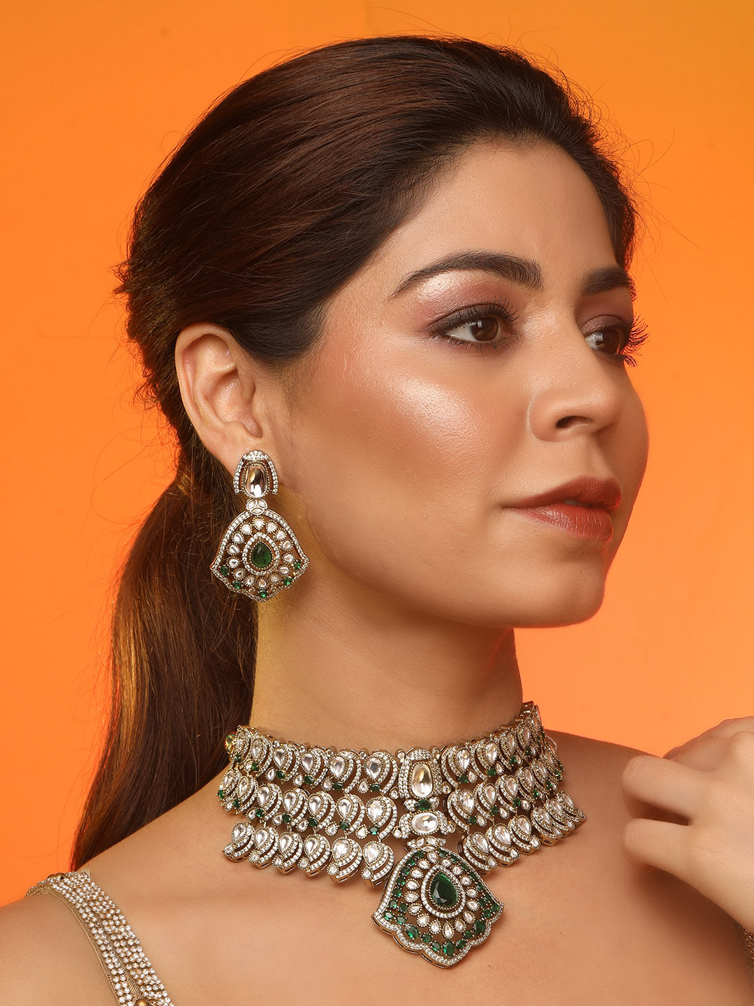 Traditional Kundan choker necklace set with green stones and matching earrings