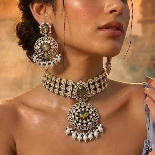 Royal blue stone Kundan choker necklace set with matching statement earrings featuring white Kundan stones, blue center stones, and pearl drop detailing.
