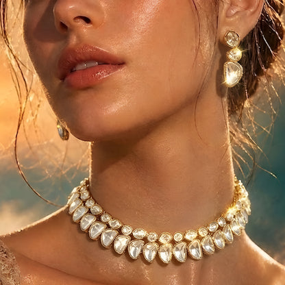 Luxury gold-tone Kundan statement necklace with clear uncut stones in an elegant crescent design for bridal and wedding jewelry.