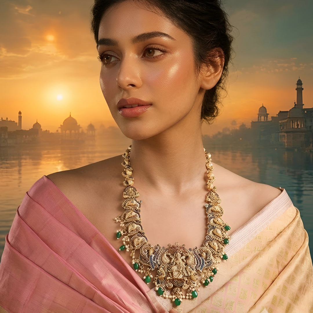 Antique gold Lakshmi temple necklace featuring traditional South Indian craftsmanship, ruby and green stone detailing, intricate deity motifs, and green bead drops for bridal and festive occasions.