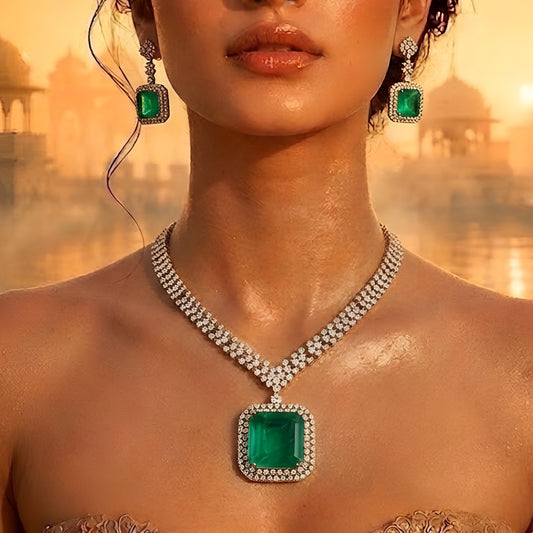 Elegant emerald green crystal pendant necklace set with sparkling zircon-studded chain and matching drop earrings in a gold-tone finish.