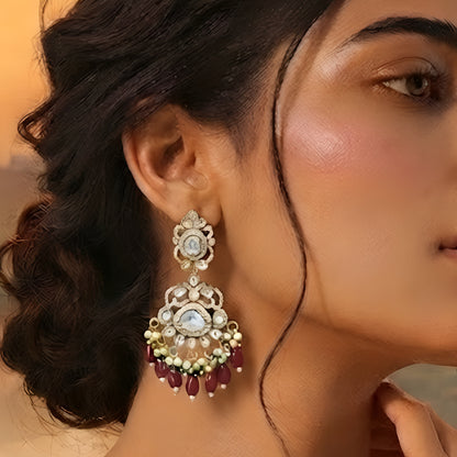 Antique gold Kundan Chandbali earrings with ruby bead drops, pearl clusters, and traditional bridal design for women.