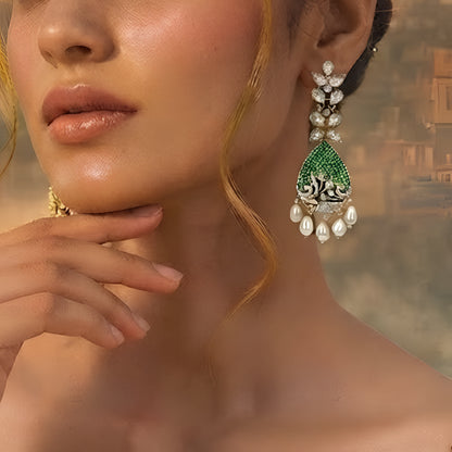 Luxury gold-plated teardrop earrings with emerald green stones, sparkling American diamonds, and pearl drop danglers for women.