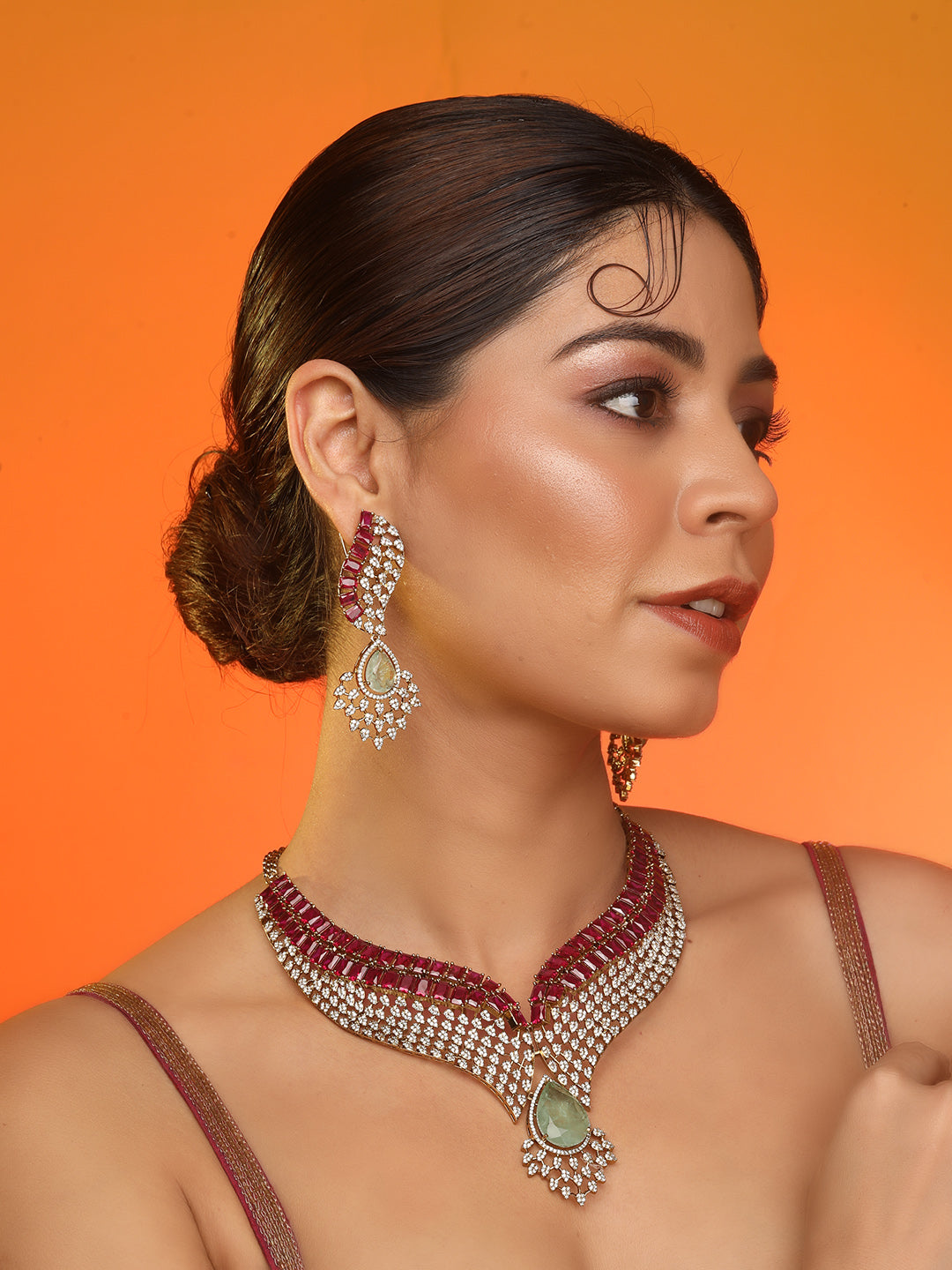 Gold plated ruby and emerald statement necklace set with matching earrings, bridal jewelry design with teardrop green stone and crystal detailing