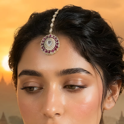 "Gold-plated pink American diamond bridal maang tikka with oval crystal centerpiece and marquise stones for women on white background."