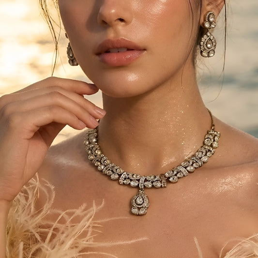 Gold-plated Kundan choker necklace set with matching drop earrings featuring teardrop stones and bridal-inspired traditional design.