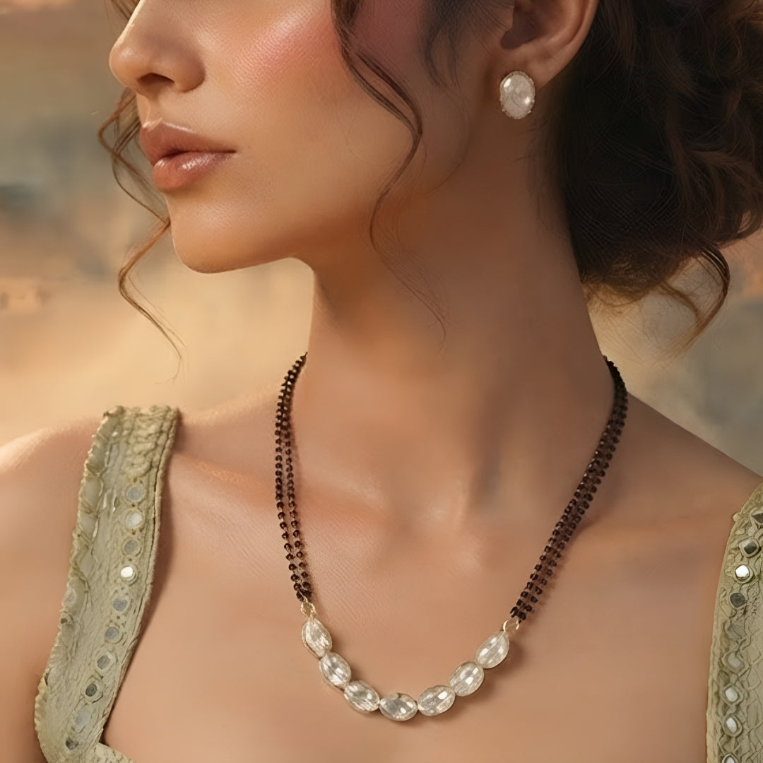 Elegant oval stone black beads mangalsutra necklace set with matching stud earrings for women in gold-tone finish