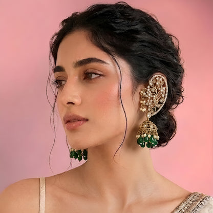 Luxury gold-plated Kundan Polki ear cuff jhumka earrings with green bead drops and pearl detailing for bridal and festive wear.