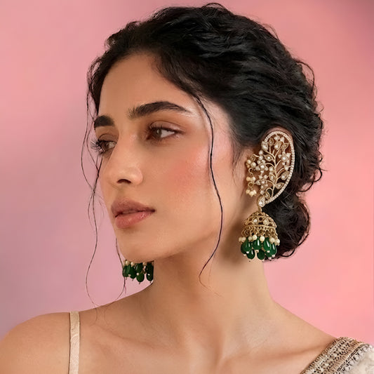 Luxury gold-plated Kundan Polki ear cuff jhumka earrings with green bead drops and pearl detailing for bridal and festive wear.