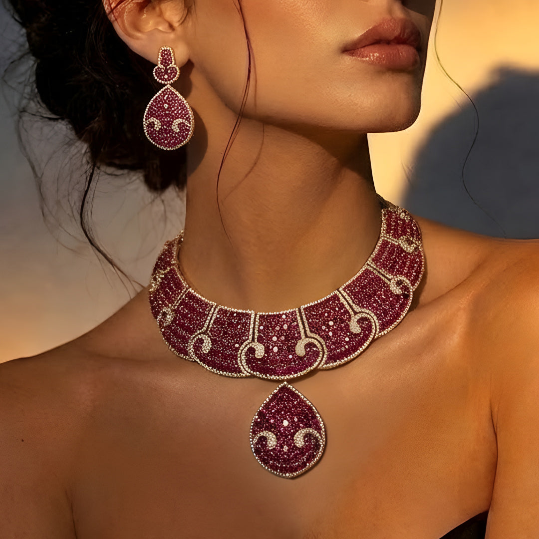Luxury ruby pink crystal statement choker necklace set with teardrop pendant and matching earrings for weddings and festive occasions.