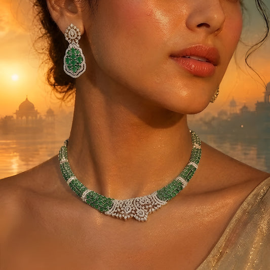 Silver-toned emerald green crystal choker necklace set featuring sparkling stone detailing and matching statement drop earrings on a white background.