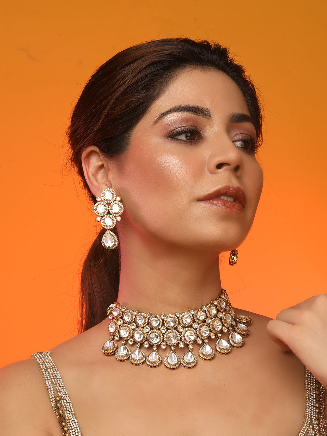 Gold-plated Kundan choker necklace set with teardrop stones and matching earrings for bridal and wedding wear