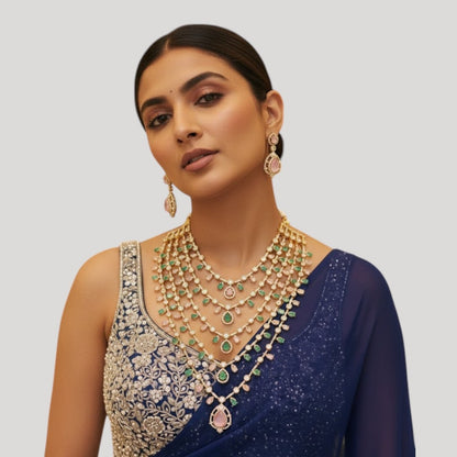 "Multi-layered gold-plated Kundan necklace set with pastel pink and green stones and matching earrings"