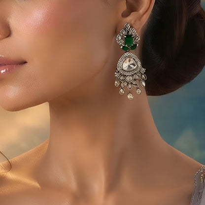 Luxury gold-plated statement earrings with emerald green stones, Kundan stones, sparkling American diamonds, and teardrop danglers for women.