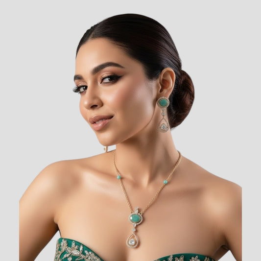 “Gold-plated necklace and matching earrings set with turquoise stones and crystal-accented teardrop pendants.”