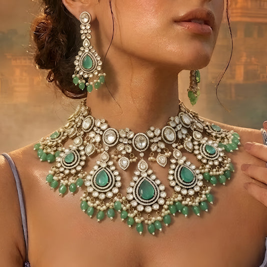 Luxury green Kundan bridal choker necklace set with matching earrings featuring white Kundan stones, green teardrop gemstones, and pearl bead detailing.