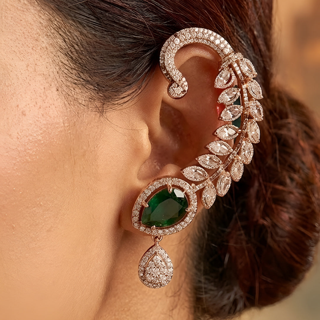 Gold-plated leaf design ear cuff earrings with emerald green teardrop stones and sparkling crystal embellishments for women.