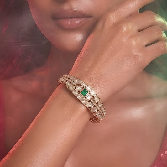Green stone AD studded gold tone designer kada bracelet with intricate leaf detailing